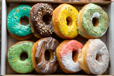 Delicious and tempting box full of colour donuts.の写真素材