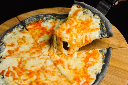 Cheese Pizza, black pastry on a wooden board.の写真素材