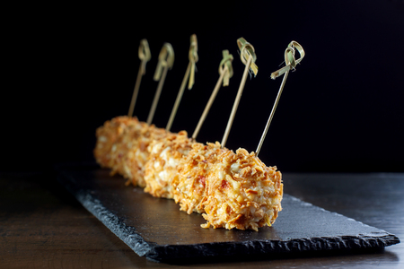 Cheese balls in breading, with natural bamboo skewers.の写真素材