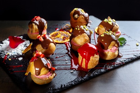 Traditional french eclairs with chocolate and nuts.