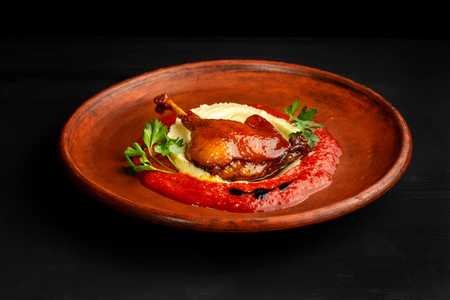 Roasted duck leg with mashed potatoes and tomato sauce.の写真素材