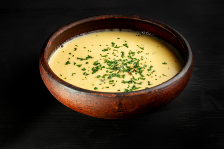 Roasted pumpkin soup with cream on black wooden background.の写真素材