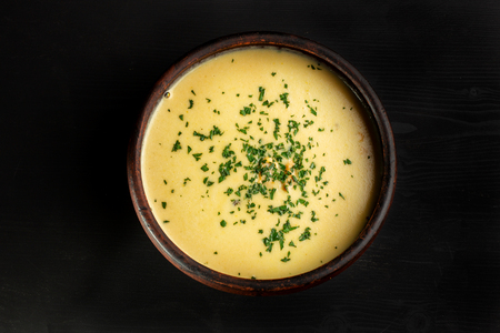 Roasted pumpkin soup with cream on black wooden background.の写真素材
