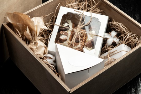 Milk chocolate with filling and cakes in a gift box tied with twine.の写真素材