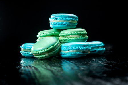 Delicious macaroons isolated on black background. French sweet cookie.の写真素材