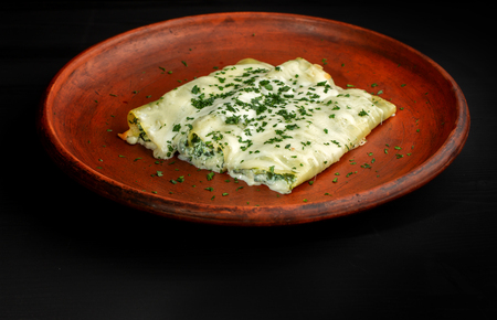 Rolls of pancakes with cottage cheese, herbs and cheese.の写真素材