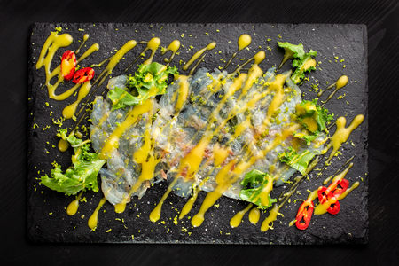 Carpaccio fish food. White fish carpaccio, poured with sauce.の写真素材