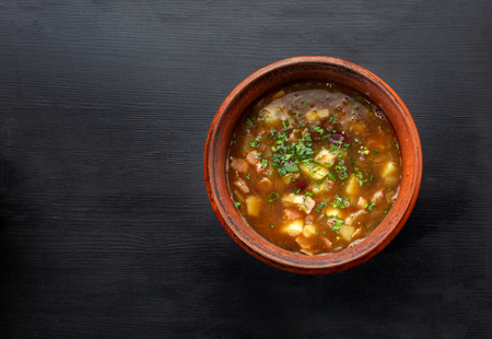 Lentil soup in a bowl on wooden black background.の写真素材