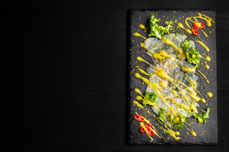 Carpaccio fish food. White fish carpaccio, poured with sauce.の写真素材