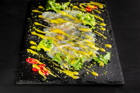 Carpaccio fish food. White fish carpaccio, poured with sauce.の写真素材