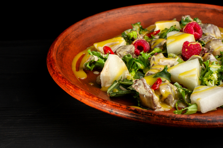 Raspberry, pineapple, lettuce and champignon salad with sauce.の写真素材