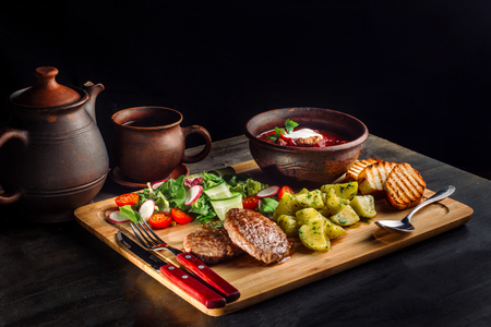Lunch with fried meatballs, soup with meat and potatoes on a rustic-2.の写真素材