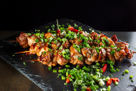 Grilled meat skewers, shish kebab on black slate.の写真素材
