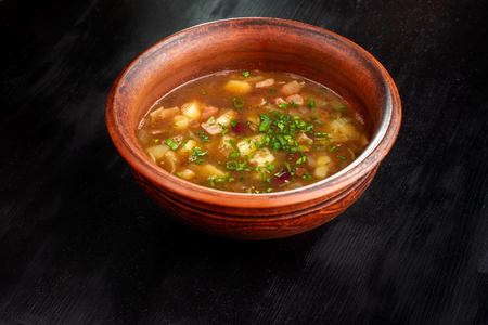 Lentil soup in a bowl on wooden black background.の写真素材