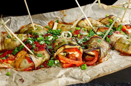 Eggplant with cheese rolled into rolls on the grill.の写真素材