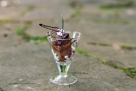 Chocolate dessert in a glass cup on the paving slabs.の写真素材