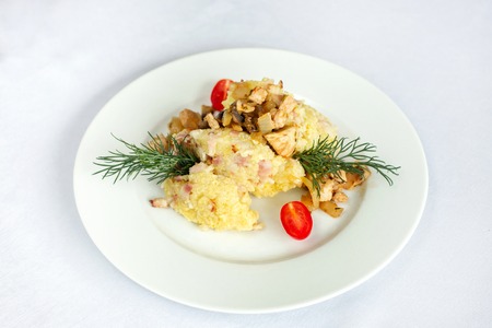 Barley porridge with grilled meat, onions and dill.の写真素材