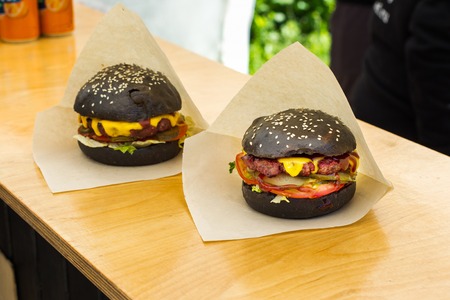 Appetizing hamburger. Pickles, onion, and cheddar cheese.の写真素材