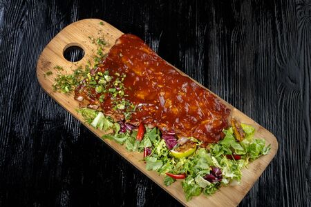 Pork ribs with sauce laid out on a wooden board,の写真素材