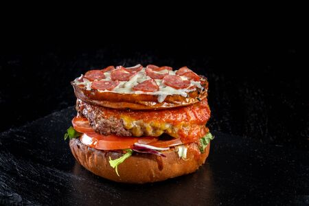 Crispy burger with sausages, tomatoes sauce, flowing mozzarella, pork meat steak-2.の写真素材