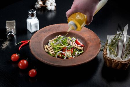 Fresh salad with grilled cheese, tomatoes, olives, lettuce and arugula.の写真素材