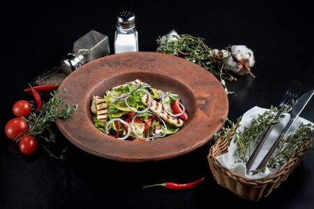 Fresh salad with grilled cheese, tomatoes, olives, lettuce and arugula.の写真素材
