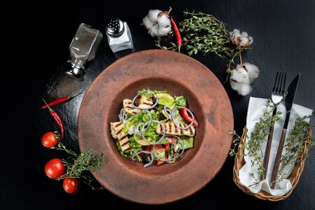 Fresh salad with grilled cheese, tomatoes, olives, lettuce and arugula.の写真素材