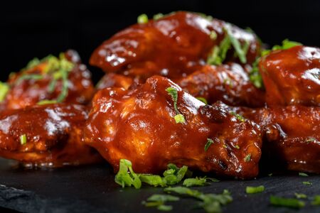 Chicken Wings with tomato barbecue sauce. Sprinkled with dill, onions and parsley.の写真素材