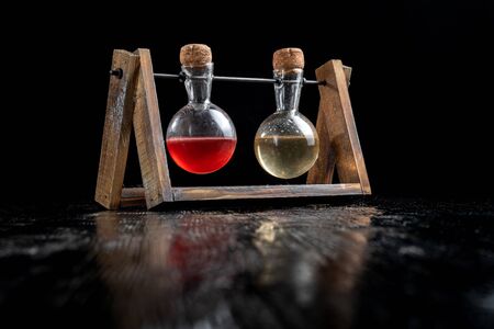 balsamic vinegar and olive oil in two glasses. Beautiful vintage jars. Beautiful reflection in the black table.の写真素材