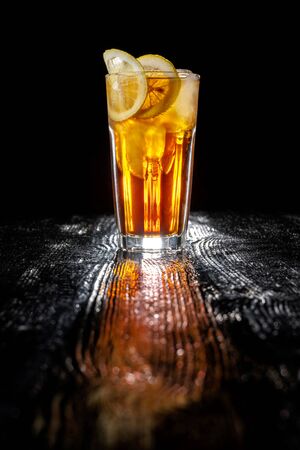 Long island ice tea. Standing on a varnished black table.の写真素材