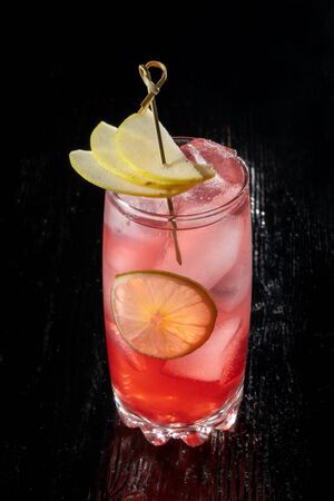 Alcoholic cocktail with juice garnished with pear.の写真素材