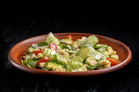 Green salad with couscous, avocado and tomato.の写真素材