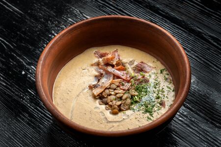 Lentil soup with smoked products in a bowl.の写真素材