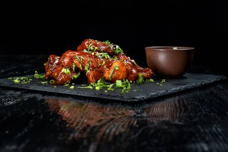 Chicken Wings with tomato barbecue sauce. Sprinkled with dill, onions and parsley.の写真素材