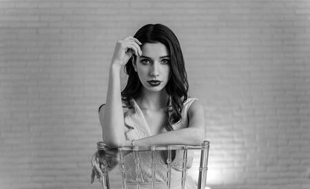 Beautiful girl bride in front of the camera, designer dress, sensual look. Black and white photography.の写真素材