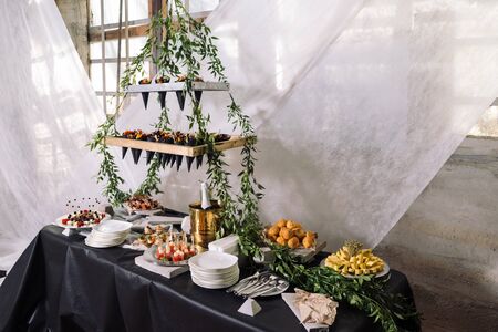 Catering, a wedding table with champagne, fruits, snacks.