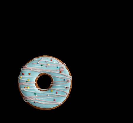 Gingerbread in the form of a donut on a black isolated background.の写真素材