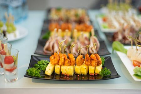 Sweet and spicy shrimps with pineapples pierced by skewers.の写真素材