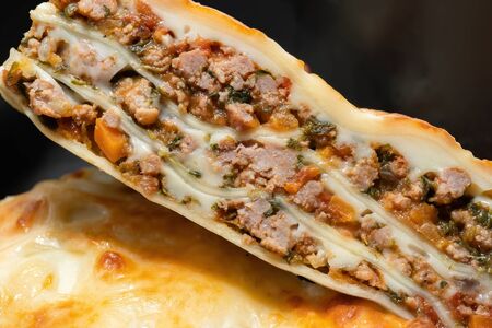 Close-up shot of hot lasagna. Stuffed with meat and vegetables.の写真素材