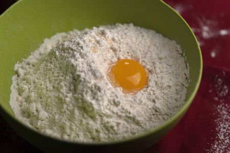 Yolk in the flour in a beautiful green plate.の写真素材