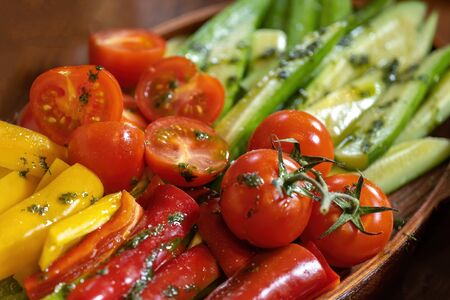 Sliced peppers, tomatoes and cucumbers, with herbs and butter.の写真素材