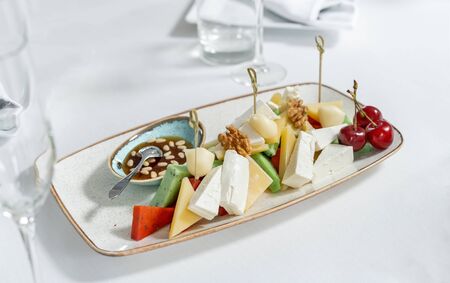 A dish with four kinds of cheese, and walnuts.の写真素材