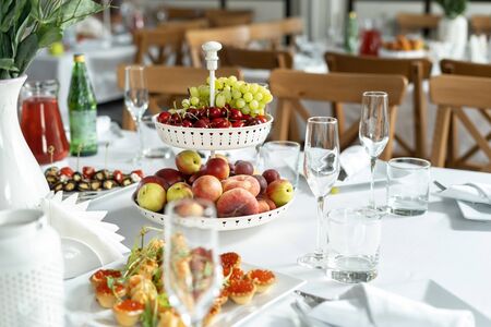 Multilevel bowl with fruits on the festive table.の写真素材