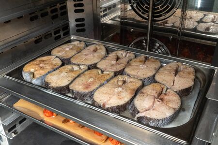 Cooking fish in the oven, restaurant. Cooking for catering.の写真素材
