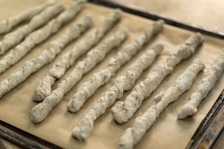 Crispy rye sticks sprinkled with flour. Rustic, laid out on a baking sheet.の写真素材