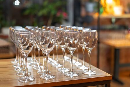 Empty wine glasses on a rack, beautiful catering.の写真素材