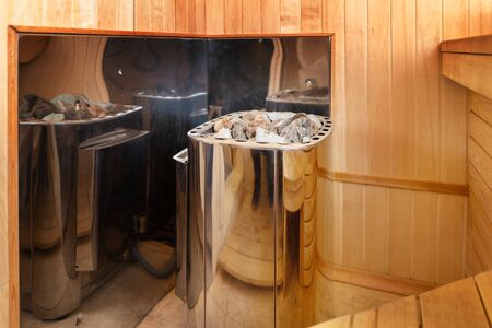Close Up of stones, electric stove in a wooden sauna. Side view.の写真素材