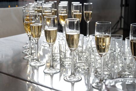 Row of glasses filled with champagne, a beautiful catering party-2.の写真素材