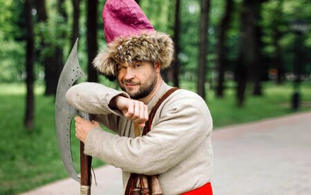 City Cossack 1st half of the 17th century. In a caftan, a fur hat in the hands of birding.の写真素材