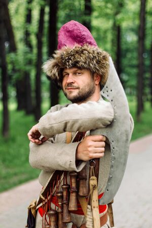 City Cossack 1st half of the 17th century. In a caftan, a fur hat in the hands of birding.の写真素材